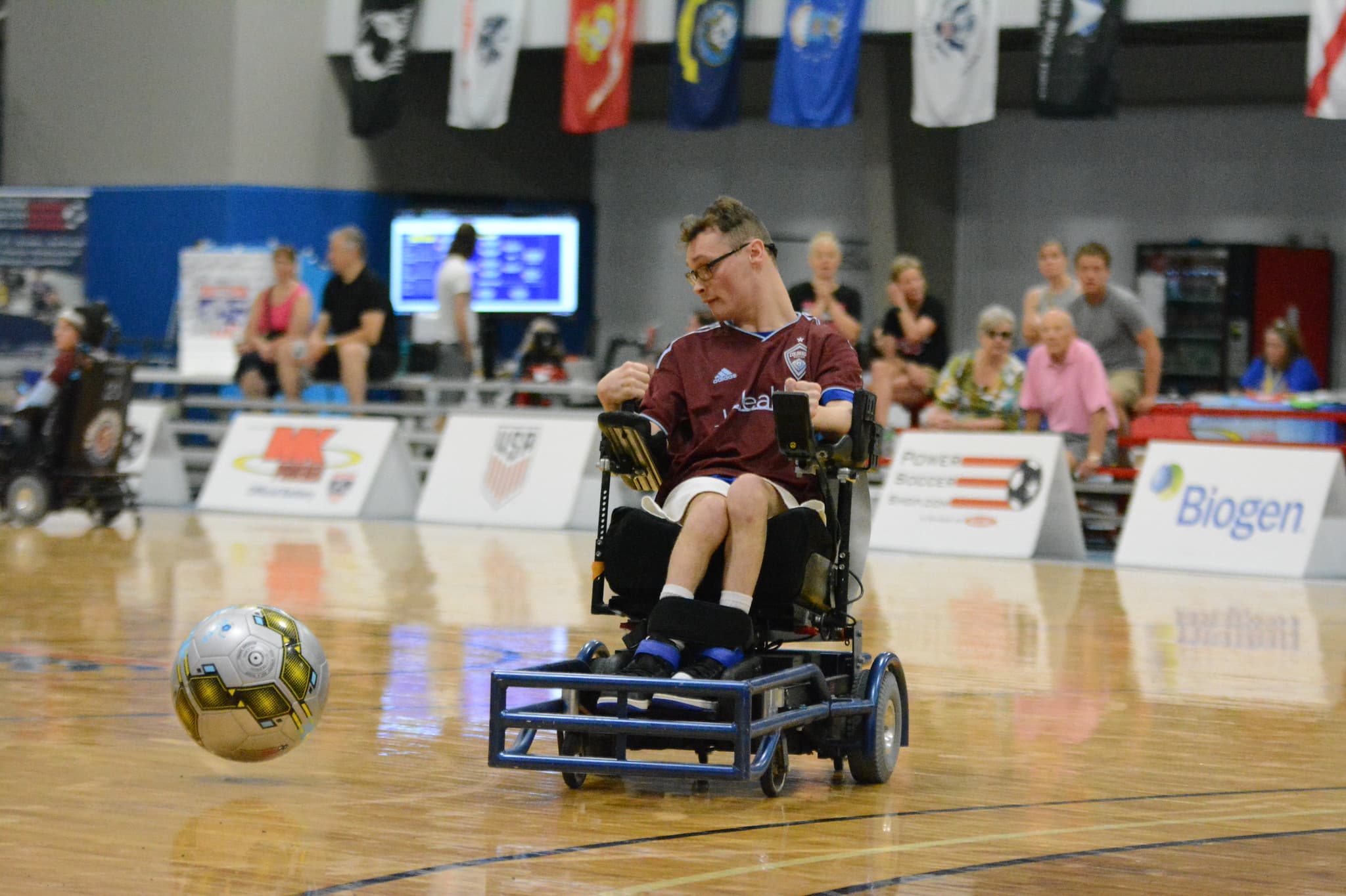 Cameron Broyles striking the ball in burgundy Rolling Rapids jersey