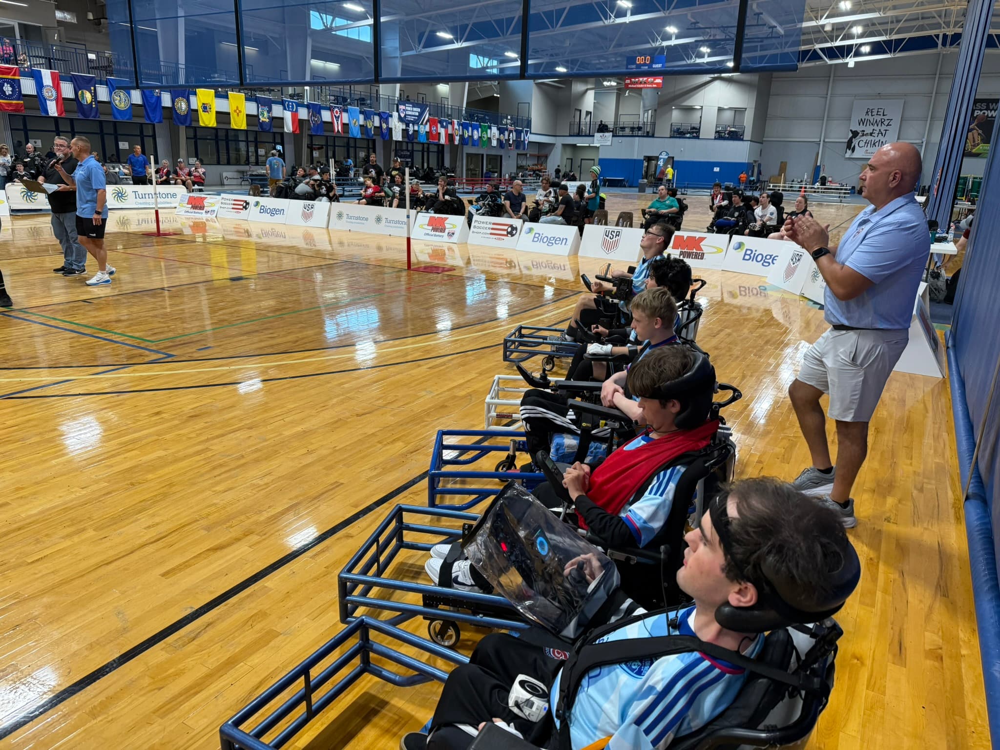 Rolling Rapids players on the sideline at a national tournament