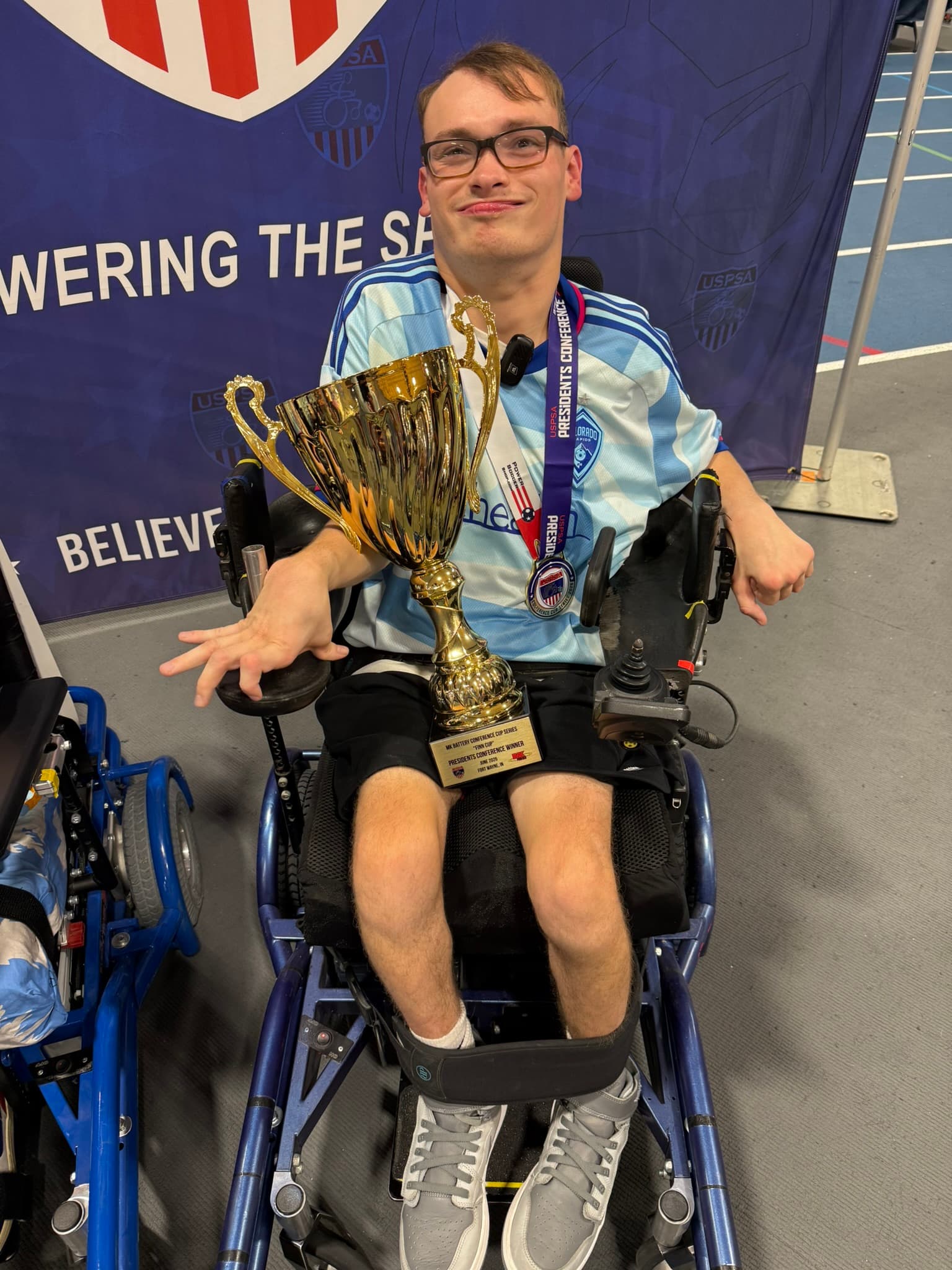 Rolling Rapids player with Presidents Conference trophy
