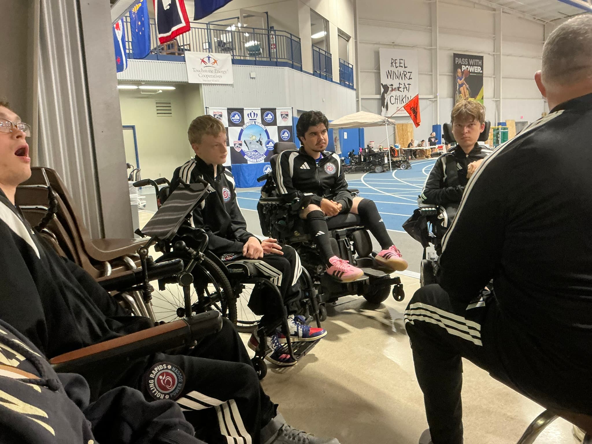 Rolling Rapids team huddle at a tournament